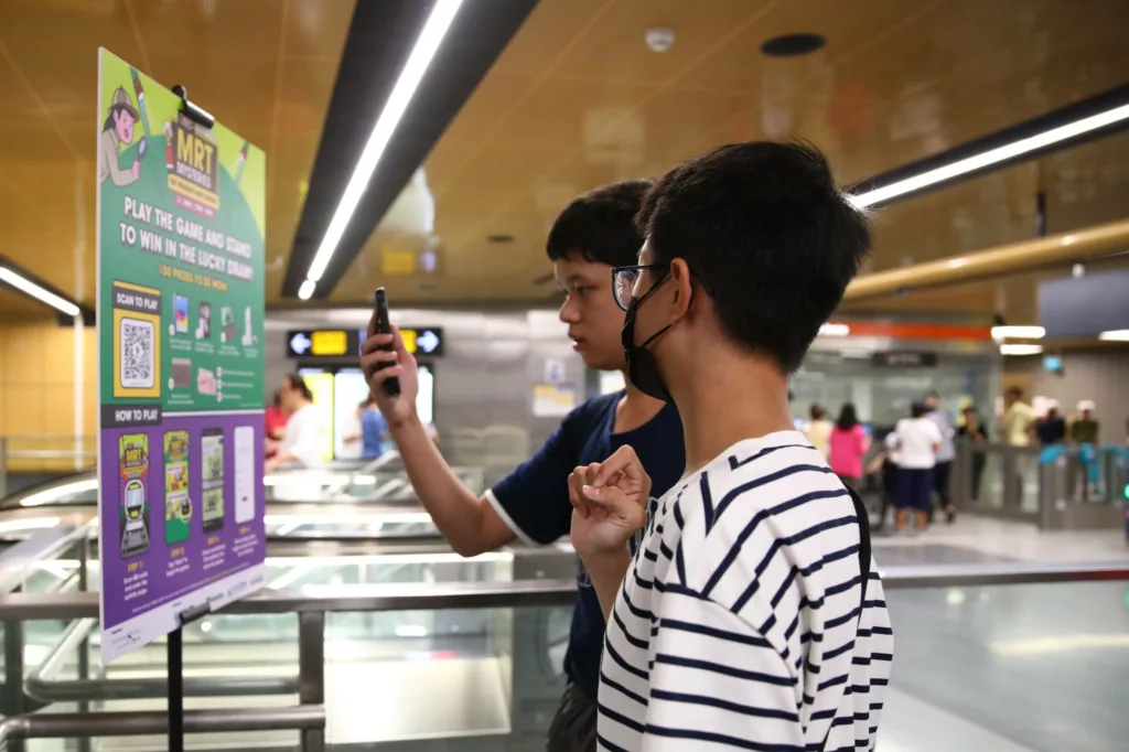 Young commuters play the MRT Mysteries Game during the TEL4 public preview in Singapore