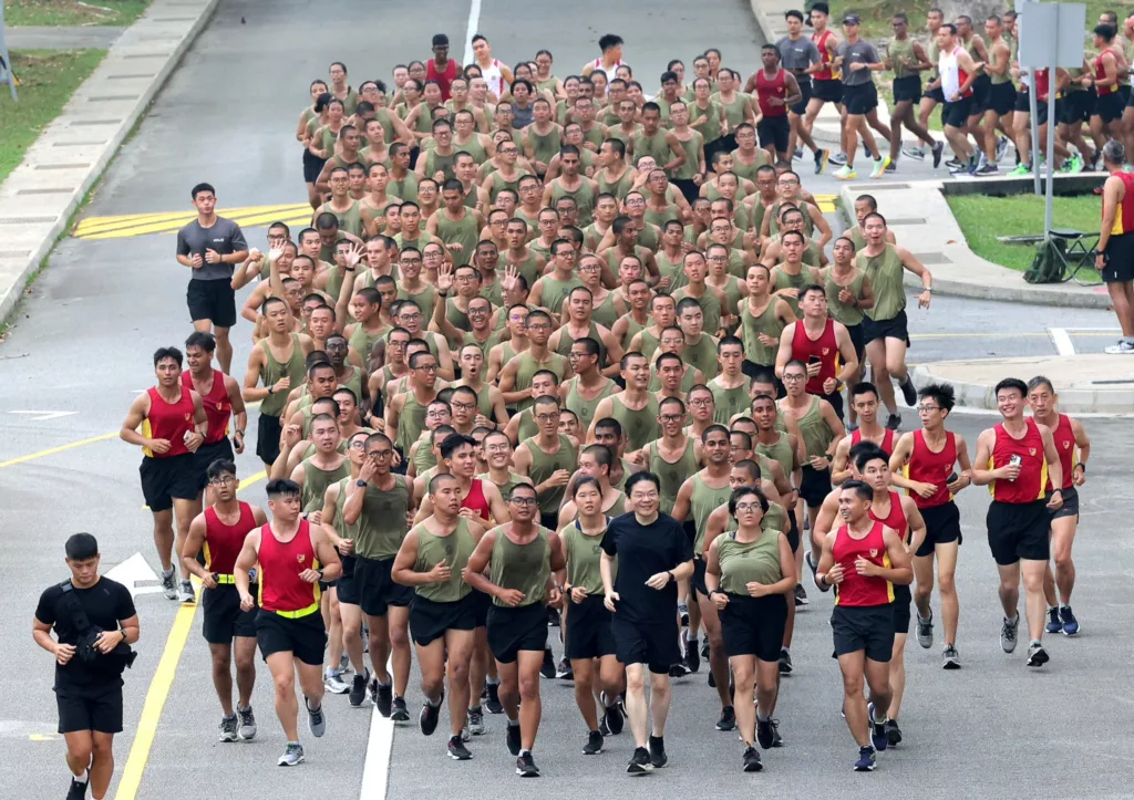 Singapore PM Lawrence Wong runs with military recruits